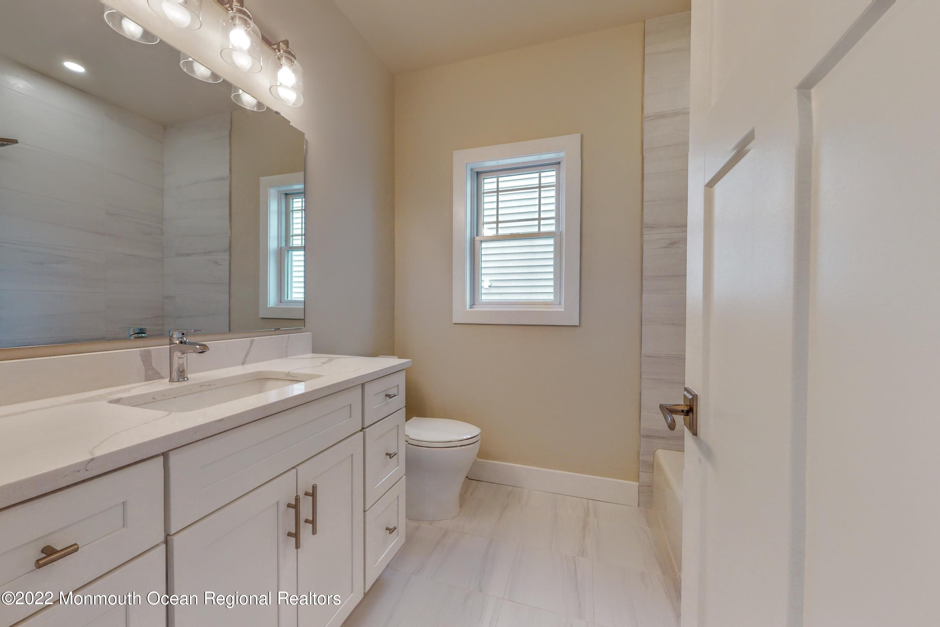 48 Muriel Drive Manahawkin, NJ 08050 - Photo 52 of 89 a bathroom with a double vanity sink toilet and shower