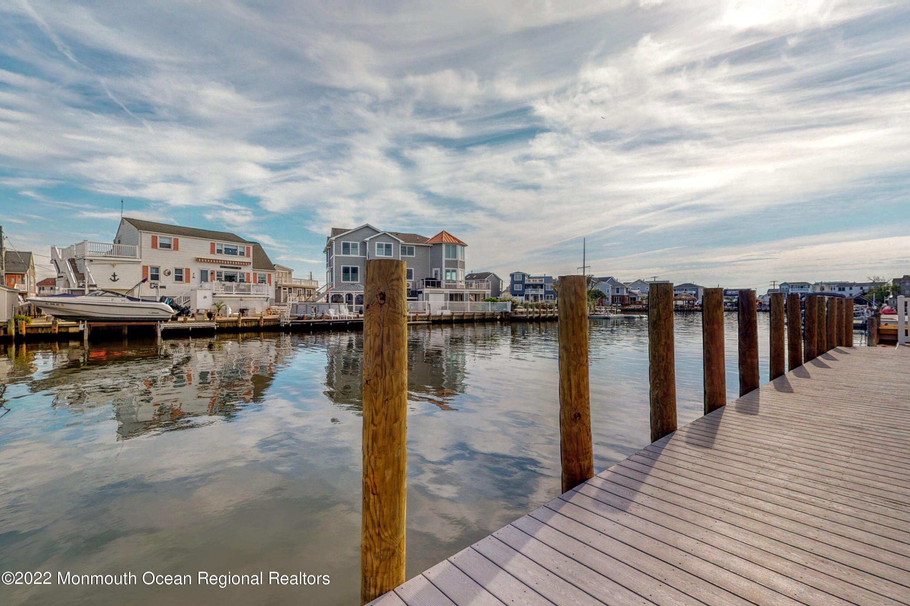 48 Muriel Drive Manahawkin, NJ 08050 - Photo 67 of 89 a view of a lake with boats and trees in the background
