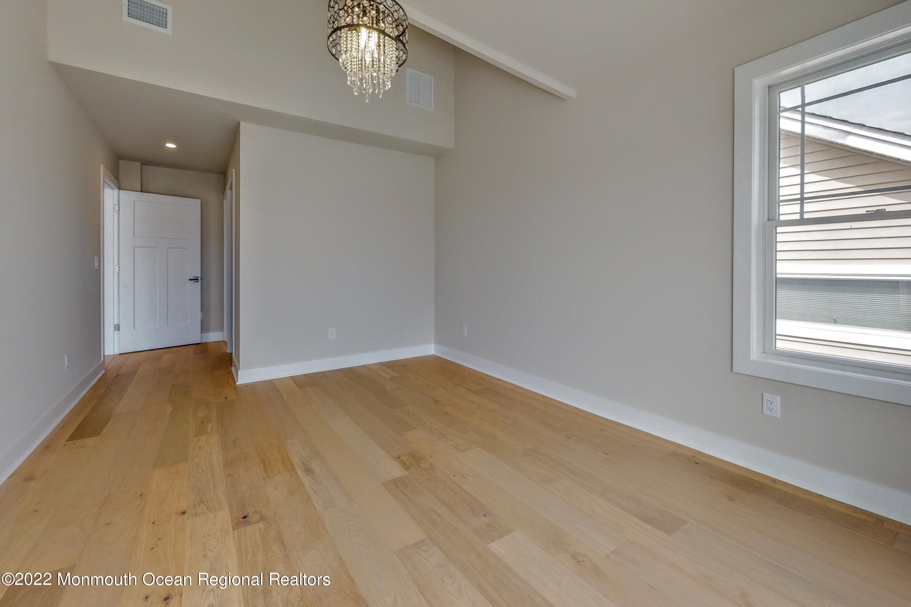 48 Muriel Drive Manahawkin, NJ 08050 - Photo 72 of 89 a view of empty room with wooden floor and fan