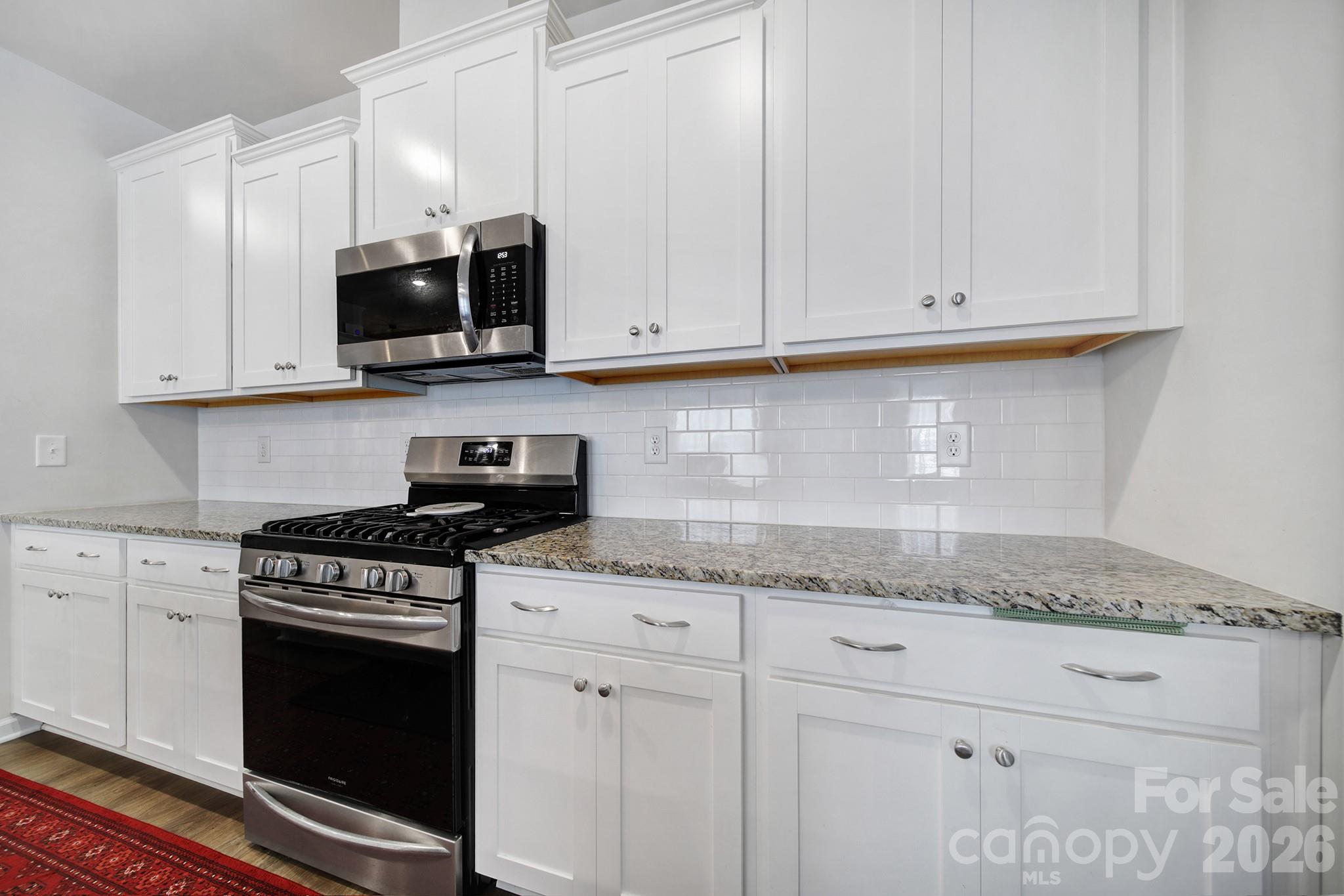6521 Gopher Road Lancaster, SC 29720 - Photo 8 of 45 a kitchen with granite countertop white cabinets and stainless steel appliances