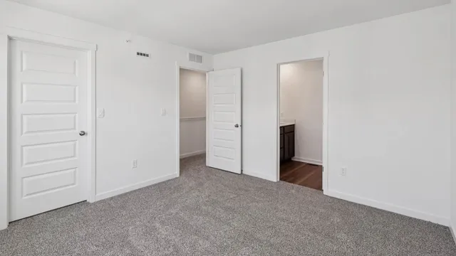 a view of an empty room and closet area