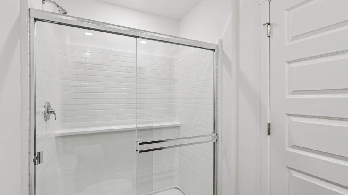 585 Yosemite Way Mundelein, IL 60060 - Photo 13 of 54 a bathroom with a glass shower door