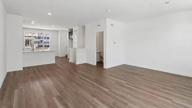 a view of wooden floor and windows in a room