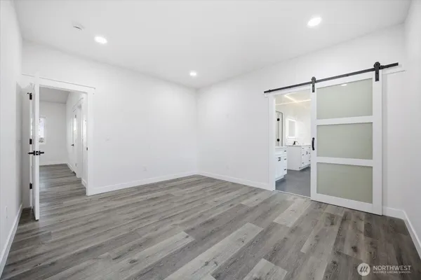 a view of empty room with wooden floor