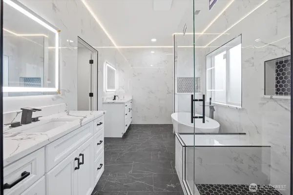 a bathroom with a double vanity sink a toilet and mirror
