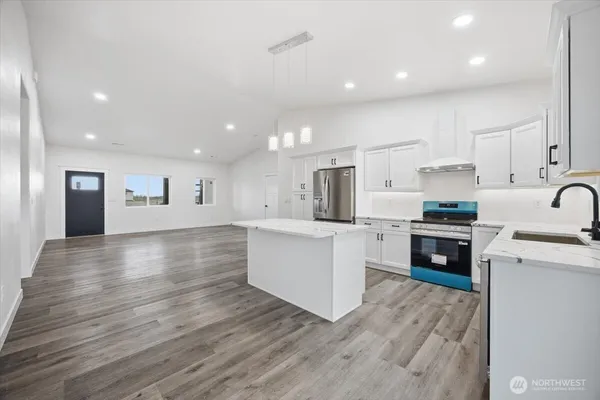 a kitchen with stainless steel appliances a refrigerator sink and cabinets