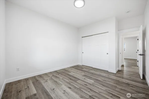a view of empty room with wooden floor
