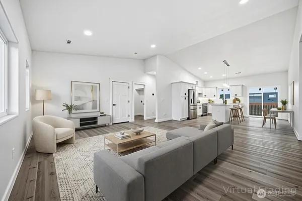 a living room with furniture and wooden floor