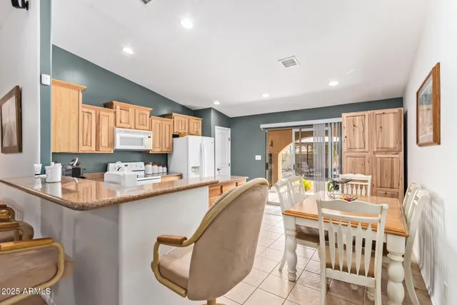 a dining room with furniture and a window
