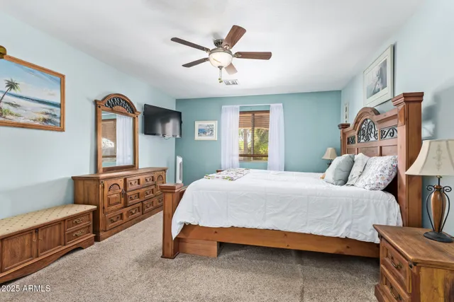 a spacious bathroom with a granite countertop sink a toilet and a mirror