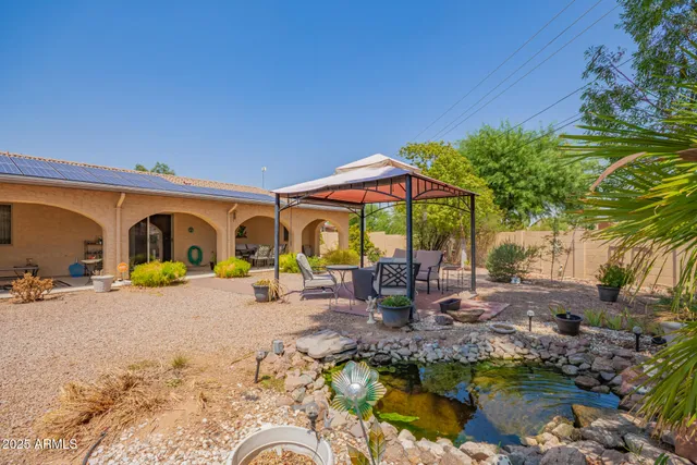 a backyard of a house with barbeque oven and outdoor seating