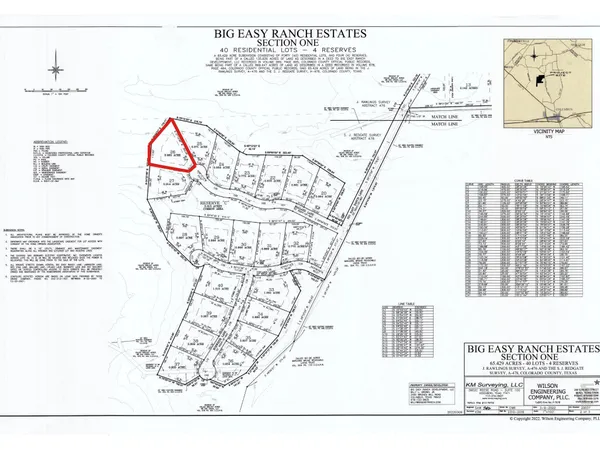 a view of dirt yard with large trees