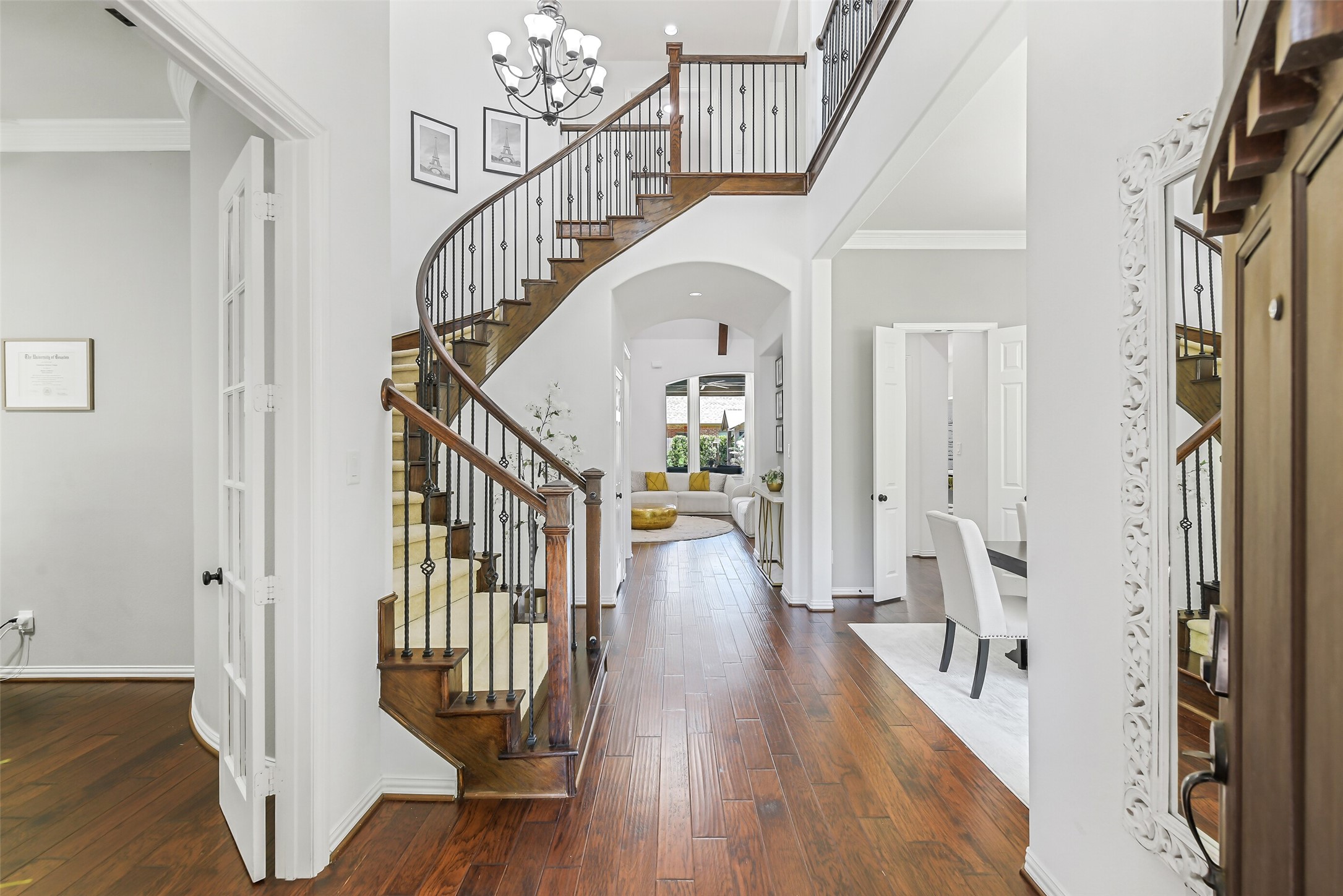 12207 Shorebridge Road Cypress, TX 77433 - Photo 4 of 41 a view of staircase with wooden floor and a chandelier