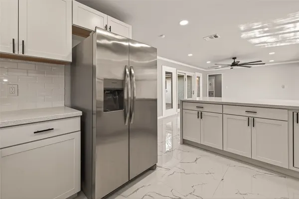 a bedroom with a bed a desk and chair with window