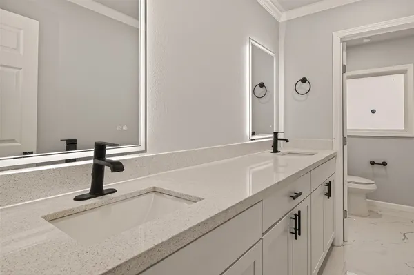 a bedroom with a bed and ceiling fan