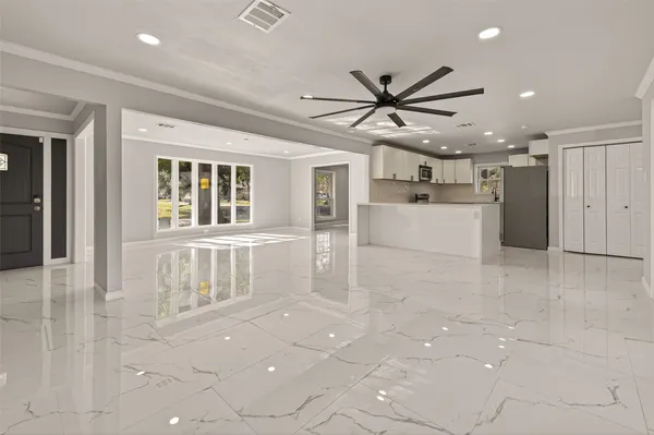 a view of a kitchen with an empty space and window