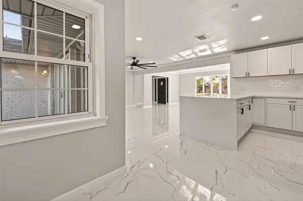 a kitchen with stainless steel appliances granite countertop a refrigerator sink and cabinets
