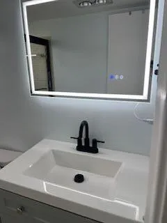 a bathroom with a sink and mirror
