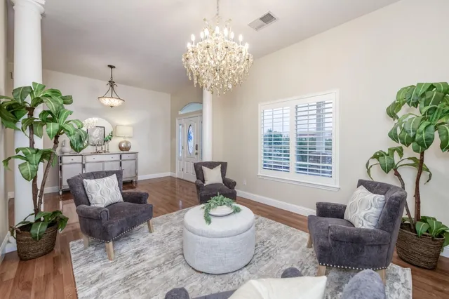 a living room with furniture a fireplace and a potted plant