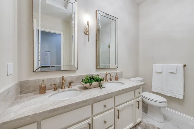 a view of a patio with table and chairs potted plants and floor to ceiling window