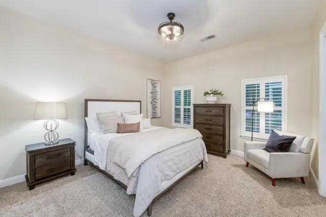 a outdoor living space with furniture potted plant and a large window