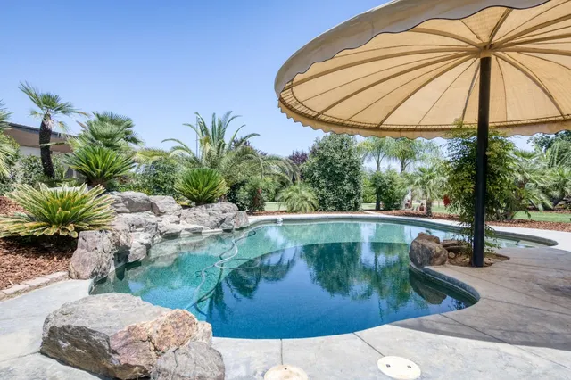 an aerial view of a residential houses with outdoor space