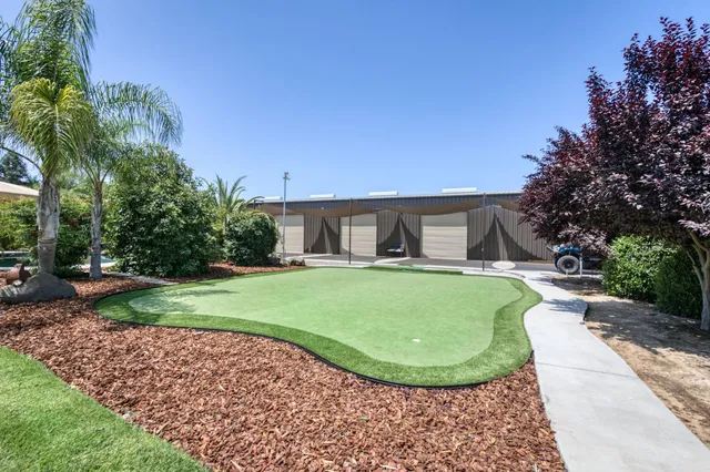 an aerial view of a house with garden space and street view