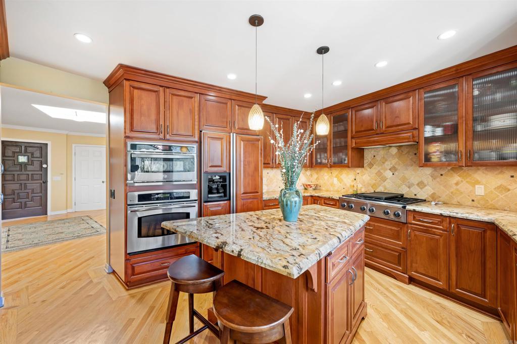 846 Val Sereno Drive Encinitas, CA 92024 - Photo 9 of 43 a kitchen with stainless steel appliances granite countertop a sink and cabinets