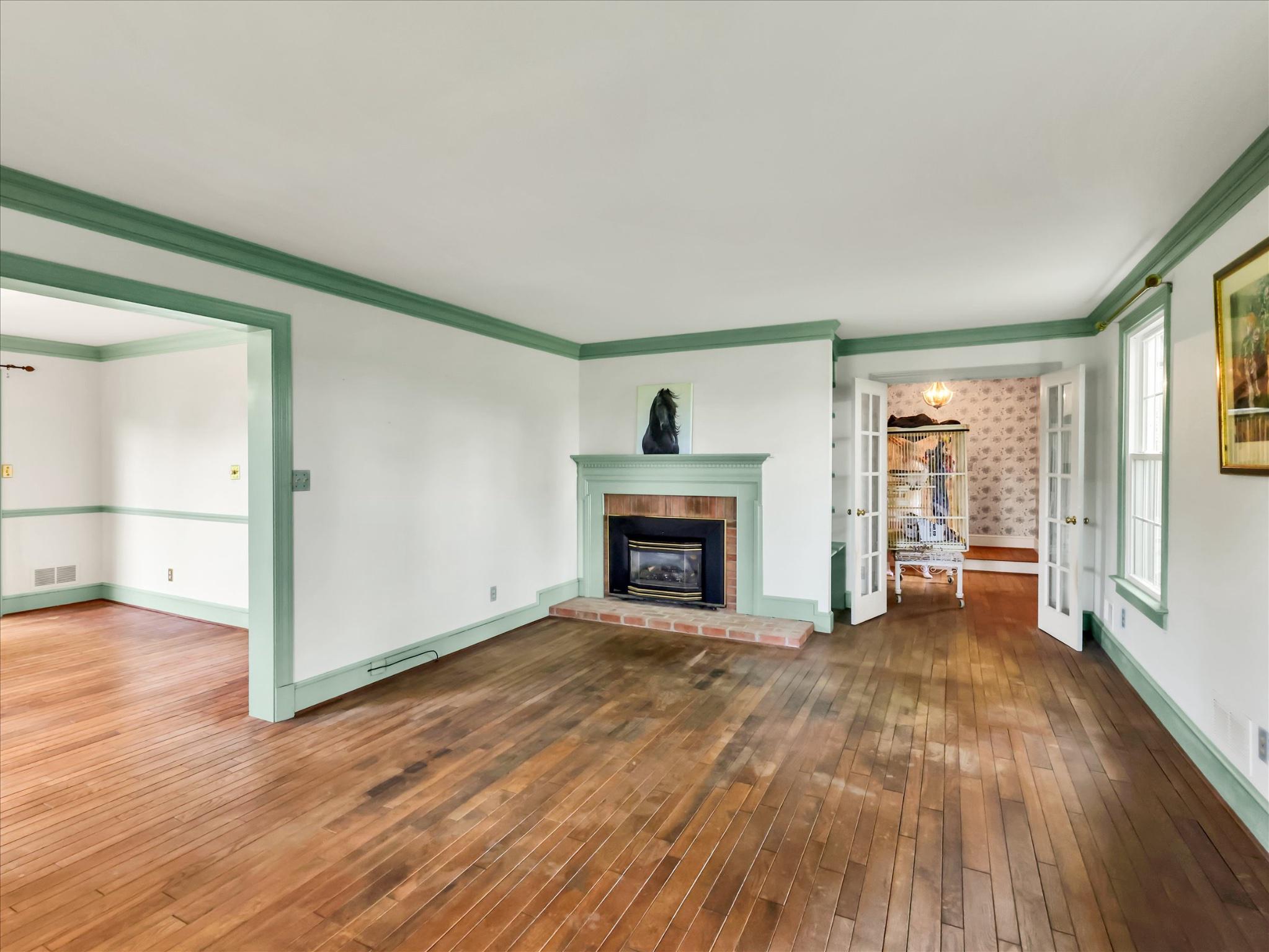 19255 Telegraph Springs Road Purcellville, VA 20132 - Photo 27 of 107 a view of an empty room with wooden floor fireplace and a window
