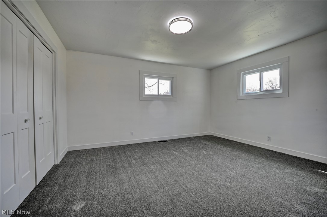 3265 York View Road Southwest New Philadelphia, OH 44663 - Photo 11 of 45 Unfurnished bedroom featuring dark colored carpet and a closet