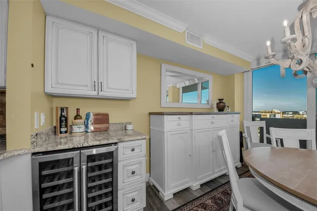a view of a dining room with furniture a chandelier and wooden floor
