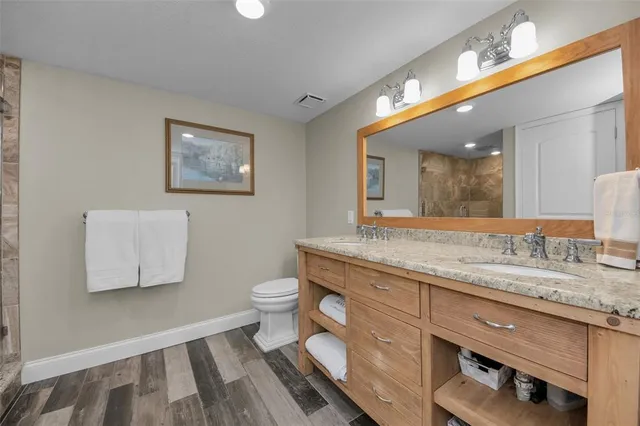 a spacious bedroom with a bed and ceiling fan