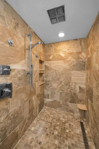 a bathroom with a granite countertop sink a toilet a mirror and shower