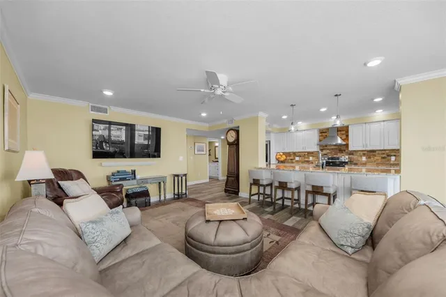 a living room kitchen with a table and chairs
