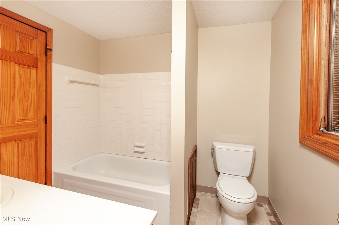 27680 Dunford Road Westlake, OH 44145 - Photo 22 of 31 Bathroom featuring shower combination, tile patterned flooring, and vanity