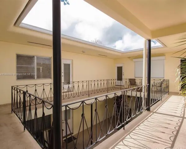 a view of a balcony with wooden floor