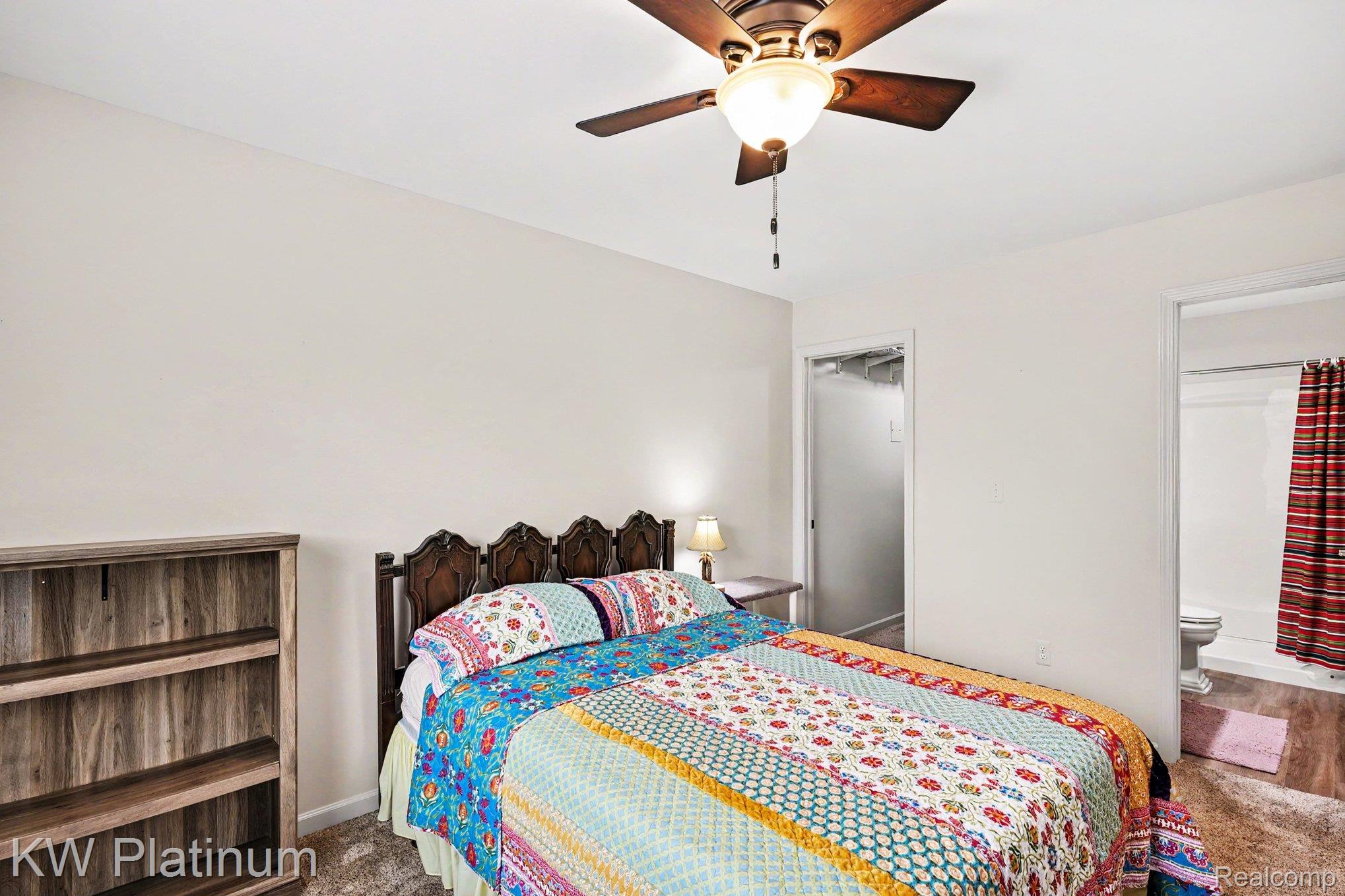 1700 River Road, Unit 6 Marysville, MI 48040 - Photo 15 of 32 Bedroom with neutral wall tones, wood-finish ceiling fan with integrated lighting, and carpeted flooring