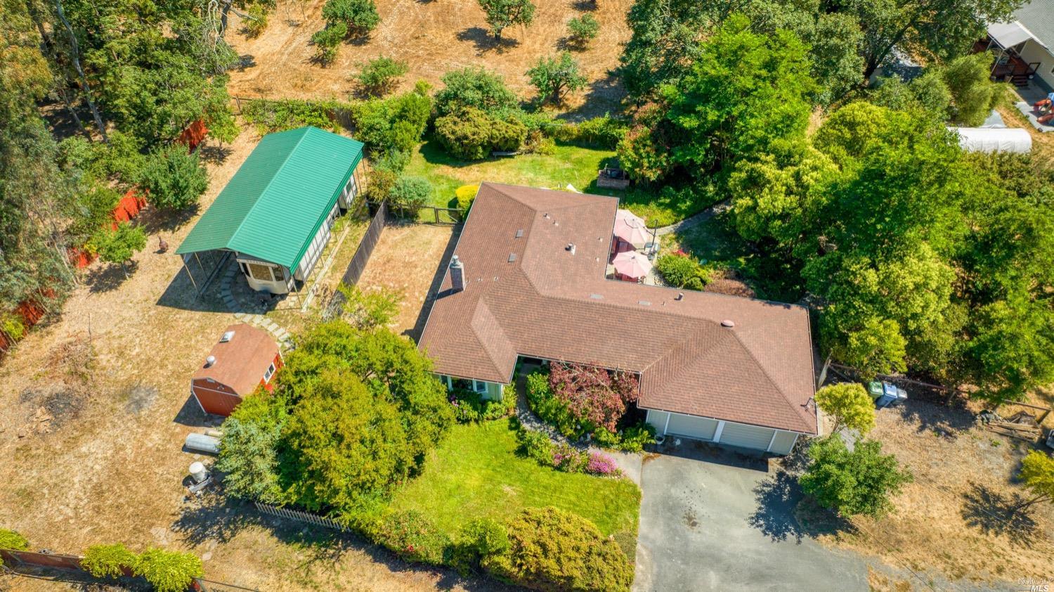 8601 Templeman Road Forestville, CA 95436 - Photo 1 of 1 RV enclosure on left hand side and house on the right with lots of trees for privacy