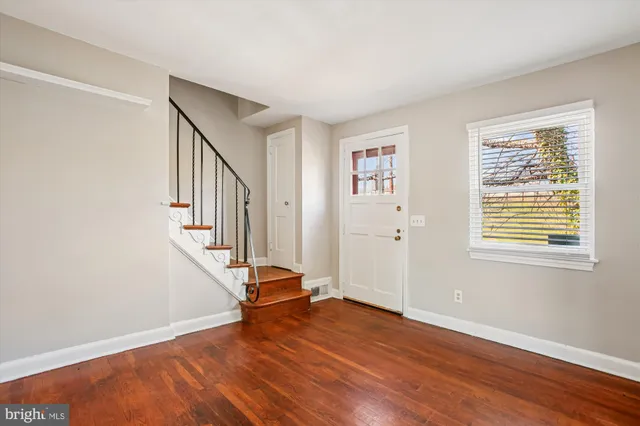 wooden floor in an empty room with a window and wooden floor