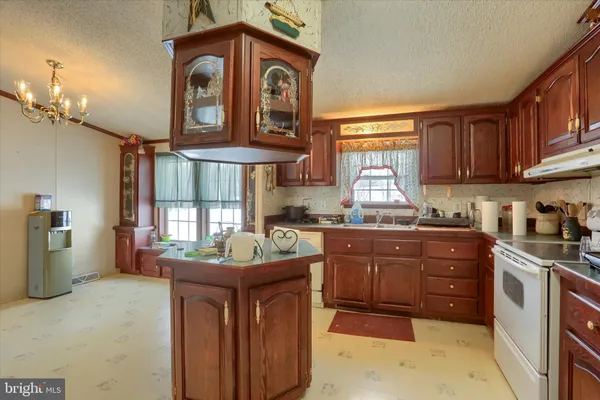 a kitchen with a stove a sink and a refrigerator