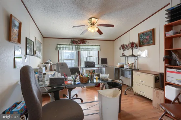 a work room with furniture and wooden floor