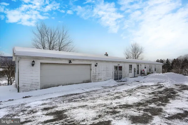 a view of a house with a snow in the yard