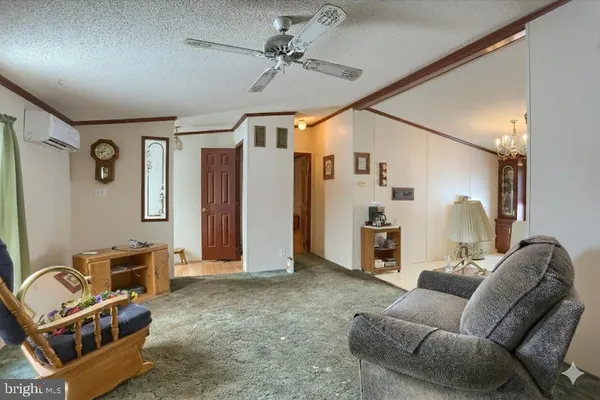 a living room with furniture and kitchen view
