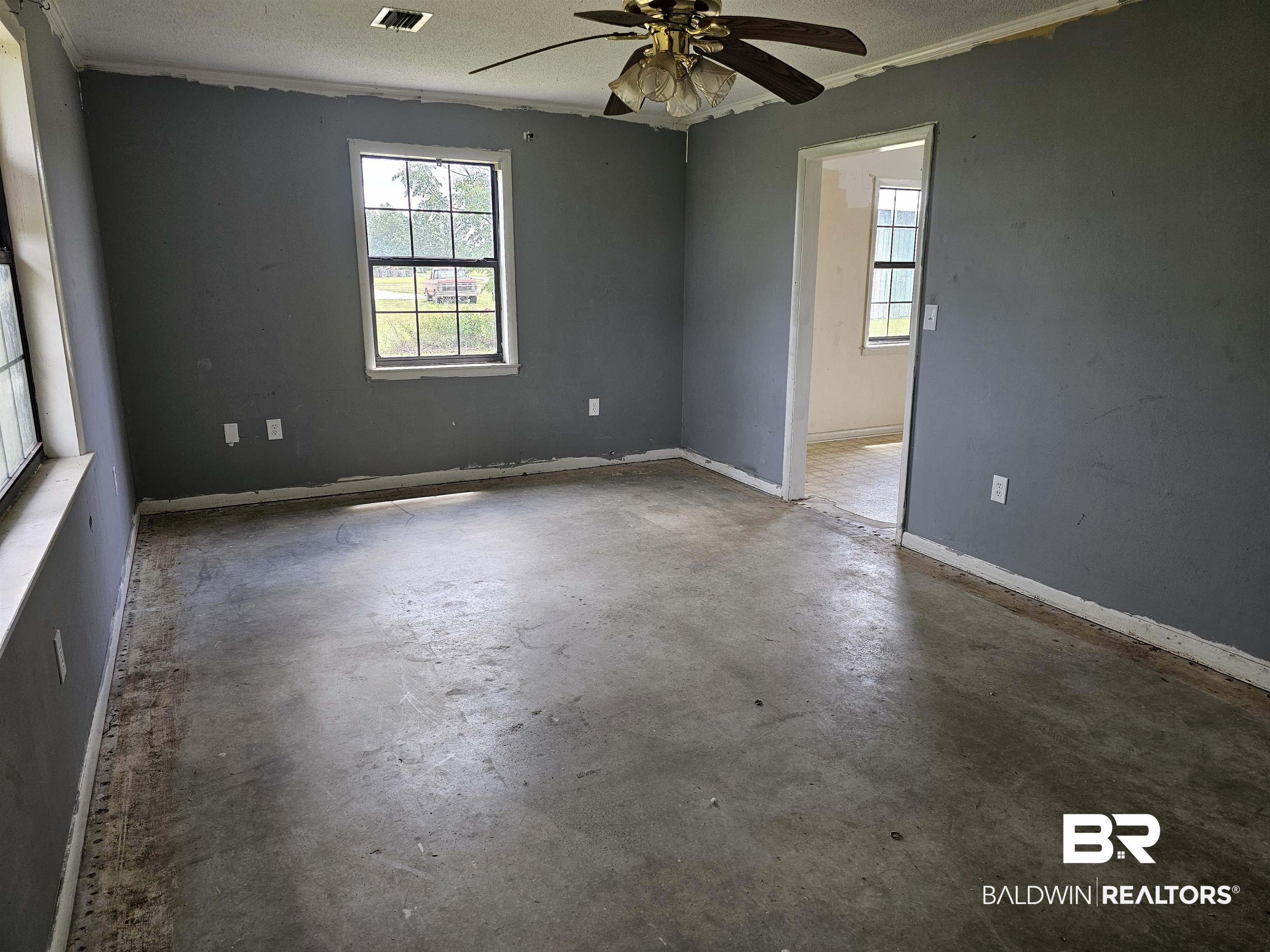 59575 Lottie Road Atmore, AL 36502 - Photo 12 of 23 Spare room with ceiling fan, unfinished concrete flooring, and a textured ceiling