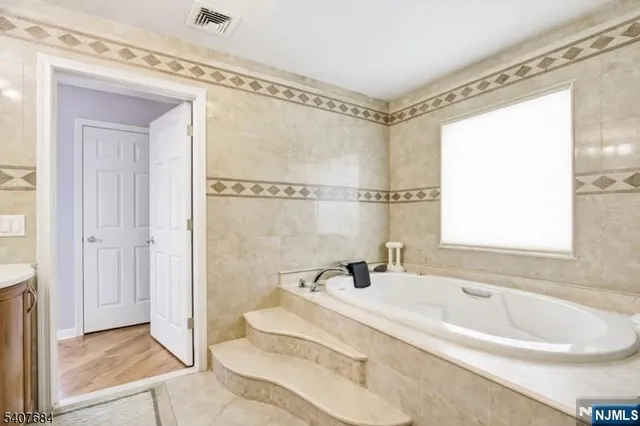 a bedroom with two beds and a window