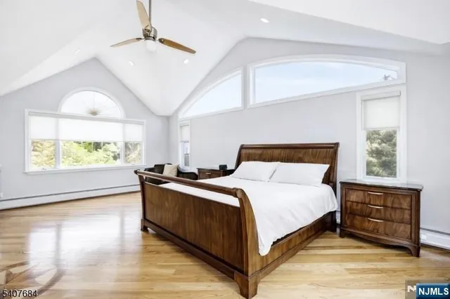 a bedroom with a large bed and a chandelier