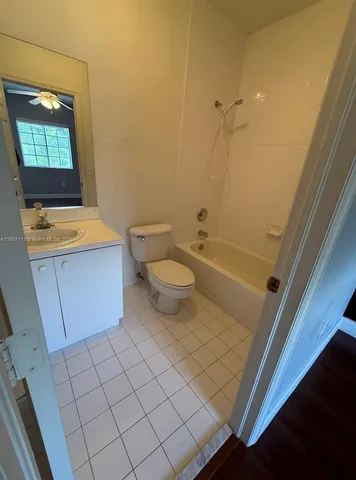 a bathroom with a sink a toilet and bathtub
