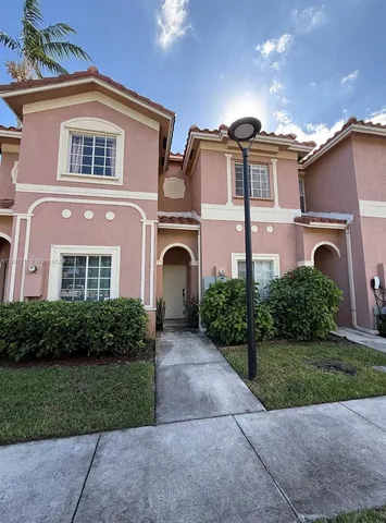a front view of a house with a yard and a garage