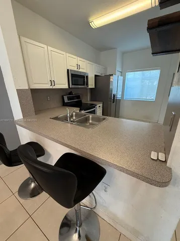 a kitchen with a sink and a stove top oven