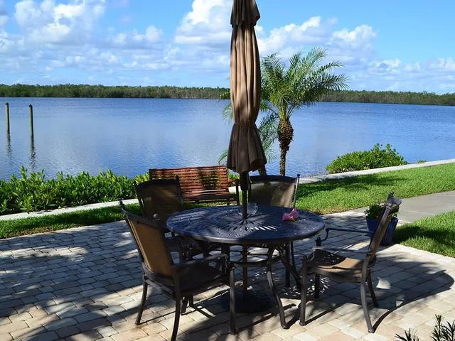 a view of a chairs and table in backyard